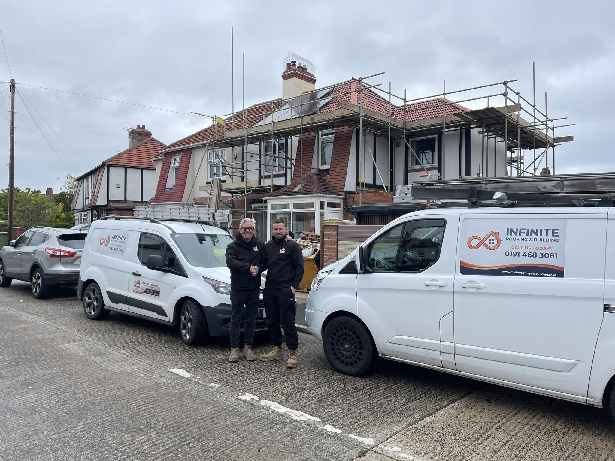 Lee and Ged, co-founders of Infinite Roofing & Building, with company vans